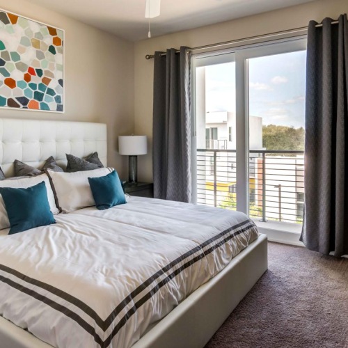 a bedroom with a bed and a large window