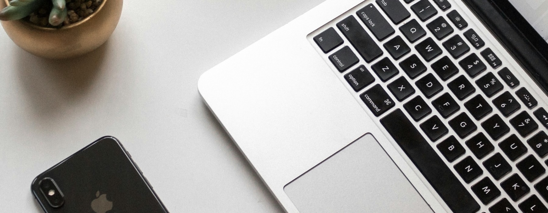 a laptop and a phone on a table