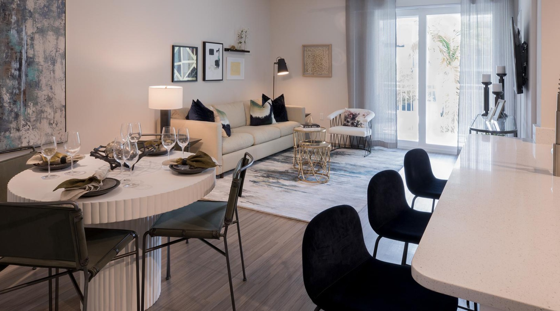 a living room and a dining table and chairs and kitchen island